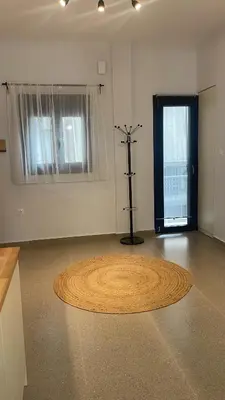 a room with a large circular rug on the floor at The Gallery in Athens