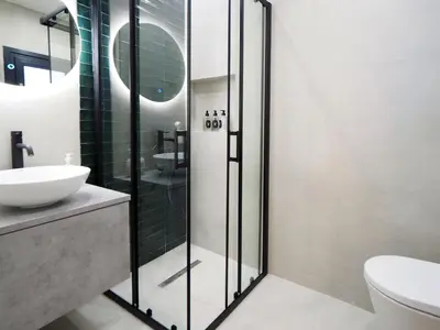 a bathroom with a glass shower and a sink at The Gallery in Athens