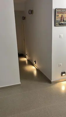 a hallway with a white wall with lights on it at The Gallery in Athens