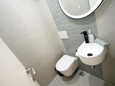 a bathroom with a toilet and a sink and a mirror at The Gallery in Athens