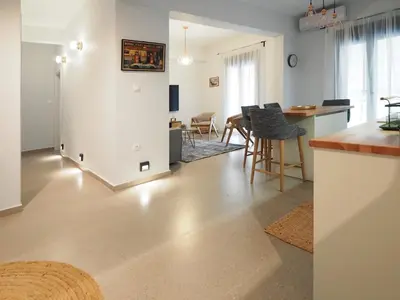 a kitchen and living room with a table and chairs at The Gallery in Athens