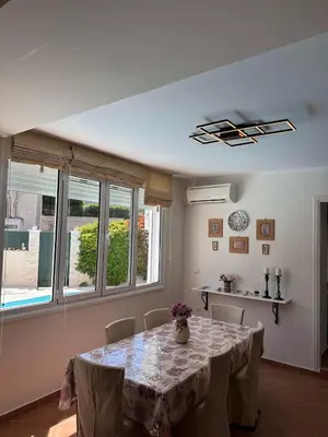 a dining room with a table and some windows at Blue Paradise Seaview villa with private pool in Sounio