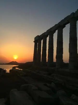an ancient temple with the sunset in the background at Blue Paradise Seaview villa with private pool in Sounio