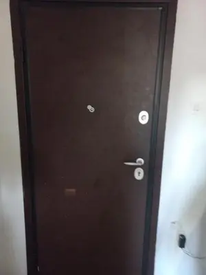 a black door with two silver knobs on it at هلال in Athens