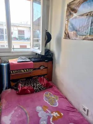 a small room with a bed and a window at هلال in Athens