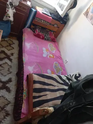 a room with a bed with a pink blanket at هلال in Athens