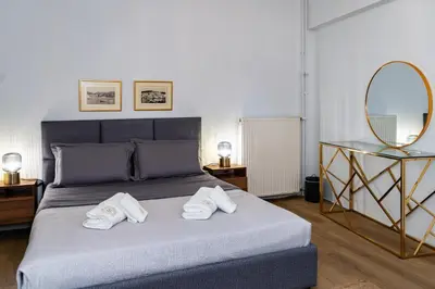 a bedroom with a bed with two towels on it at Horizon Haven in Athens