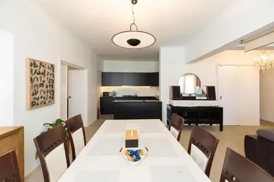 a dining room and kitchen with a table and chairs at Horizon Haven in Athens