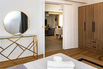 a mirror on a wall in a room with a bed at Horizon Haven in Athens
