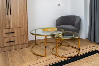 a glass table and a chair in a room at Horizon Haven in Athens