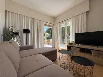 a living room with a couch and a flat screen tv at Emerald Lake Loft in Athens