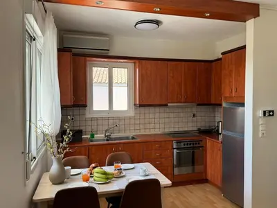 a kitchen with wooden cabinets and a table with food on it at Emerald Lake Loft in Athens