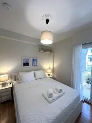 a bedroom with a white bed with towels on it at Emerald Lake Loft in Athens