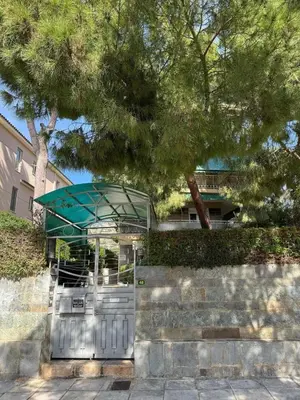 a entrance to a building with a gate and a tree at Emerald Lake Loft in Athens