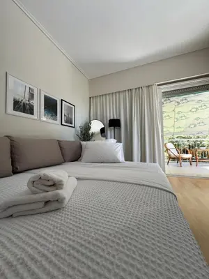 a bedroom with a large bed with white sheets at Emerald Lake Loft in Athens