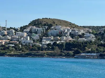 a group of houses on a hill next to the water at Emerald Lake Loft in Athens