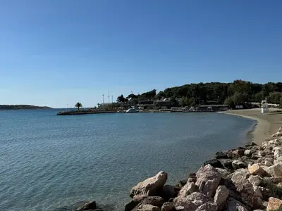 a large body of water with a beach and rocks at Emerald Lake Loft in Athens