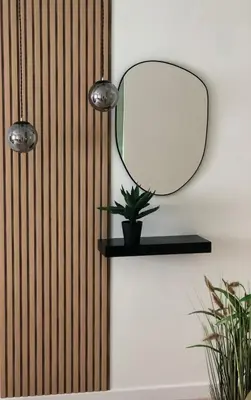 a mirror on a wall with a plant on a shelf at cozy smart house in Athens