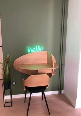 a table with a surfboard on top of a chair at cozy smart house in Athens