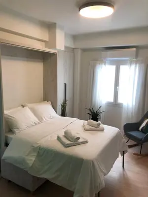 a bedroom with a bed with two towels on it at cozy smart house in Athens
