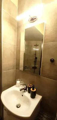a bathroom with a sink and a mirror at Near Acropolis by LV in Athens