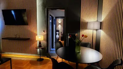 a dining room with a table and a vase of flowers at Near Acropolis by LV in Athens