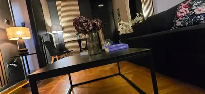 a living room with a table with a vase of flowers on it at Near Acropolis by LV in Athens
