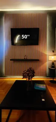 a room with a table and a tv on a wall at Near Acropolis by LV in Athens