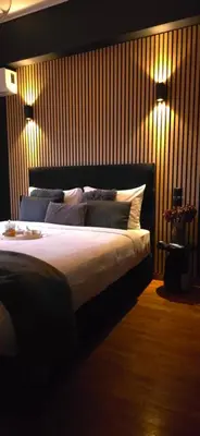 a bedroom with a bed with two lights on the wall at Near Acropolis by LV in Athens