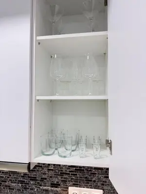 a cupboard filled with glasses on a shelf at City Vibes Athens in Athens