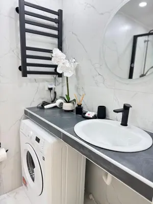 a bathroom with a sink and a washing machine at City Vibes Athens in Athens