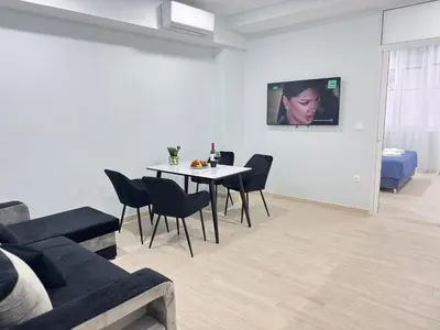 a living room with a table and a couch at City Vibes Athens in Athens