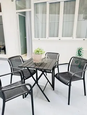 a patio table with two chairs and a potted plant at City Vibes Athens in Athens