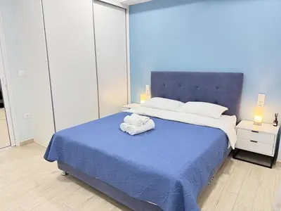 a bedroom with a large bed with towels on it at City Vibes Athens in Athens