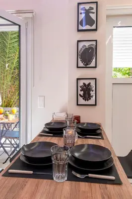 a dining room table with black plates and glasses at Modern Stay in Athens Center in Athens