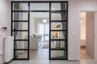a sliding glass door in a room with a living room at Modern Stay in Athens Center in Athens