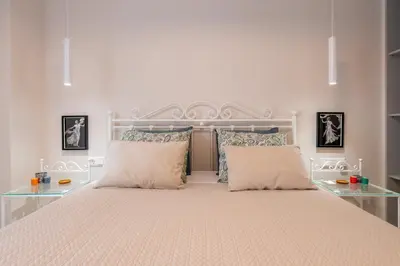 a white bed with two pillows in a bedroom at Modern Stay in Athens Center in Athens