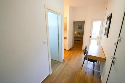 a room with a desk and a table and a hallway at Cozy Central Stay in Athens