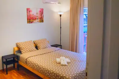 a bedroom with a bed with two teddy bears on it at Cozy Central Stay in Athens