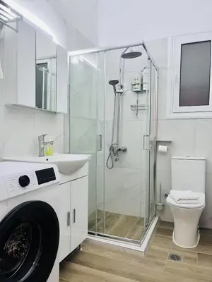 a bathroom with a shower and a sink and a toilet at Cozy Central Stay in Athens