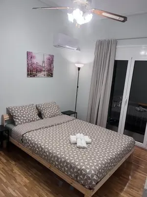 a bedroom with a bed with two white towels on it at Cozy Central Stay in Athens