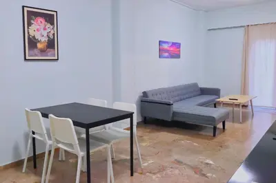 a living room with a table and a couch at Cozy Central Stay in Athens