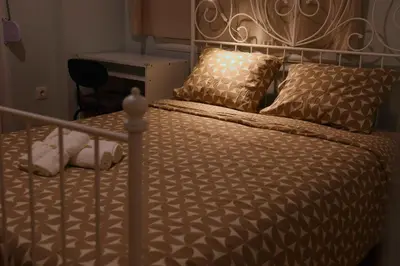 a bed with a metal bed frame and pillows at Cozy Central Stay in Athens