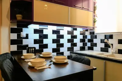 a kitchen with a table with dishes on it at Athens Neos Kosmos 2BDR apt next to metro station in Athens