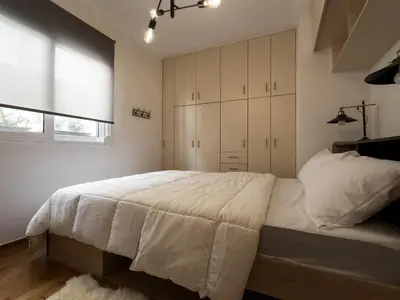 a bedroom with a large white bed and a window at Athens Neos Kosmos 2BDR apt next to metro station in Athens