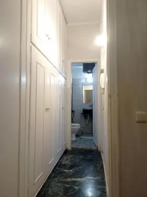a hallway of a bathroom with a toilet and a sink at Happy Rabbit 3 in Athens