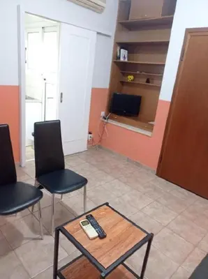 a room with two chairs and a table with a remote control at Happy Rabbit 3 in Athens
