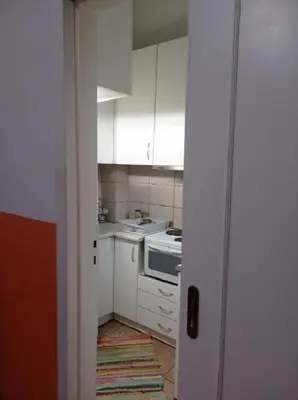 a small kitchen with white cabinets and a stove at Happy Rabbit 3 in Athens
