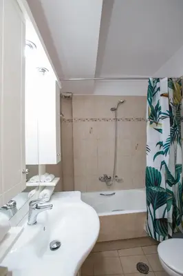 a bathroom with a sink and a tub and a shower at illusion 1 in Piraeus