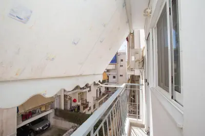 an apartment balcony with a view of a street at illusion 1 in Piraeus